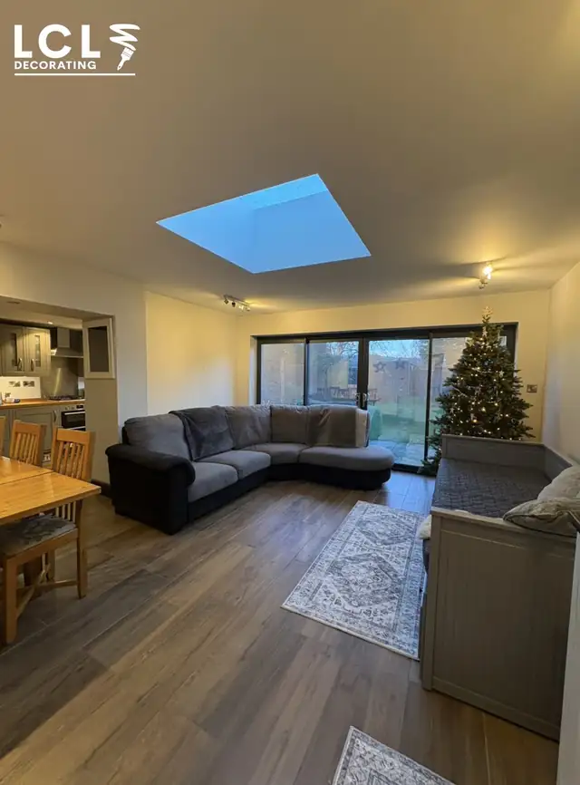 Open-plan living room with a roof lantern and bifold doors